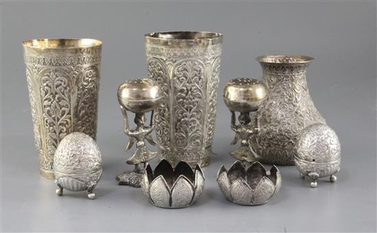 Two Indian white metal embossed beaker vases, six Indian condiments and one other Indian vase.